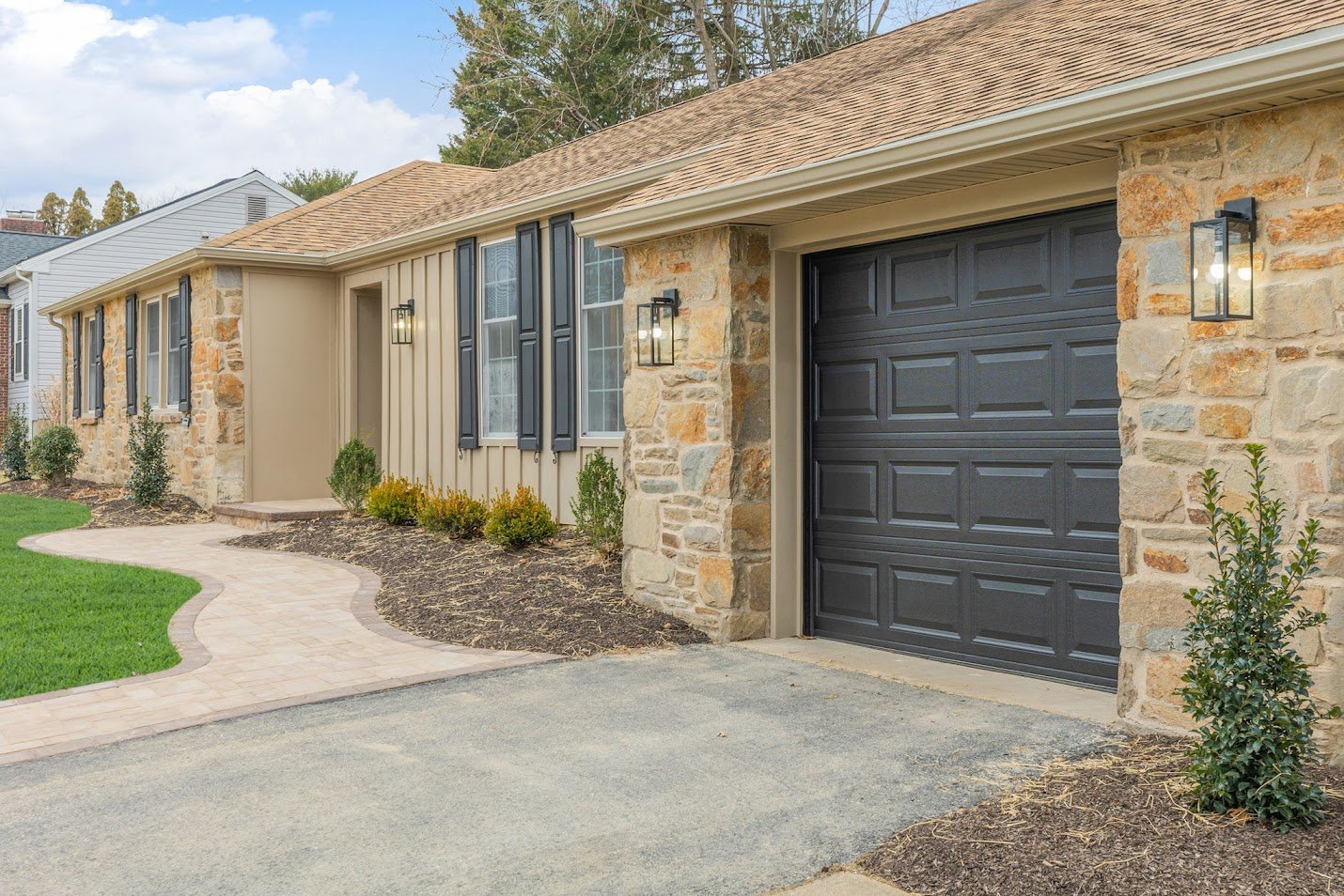 Front yard view of home by Bromwell. Ranch home with stone.