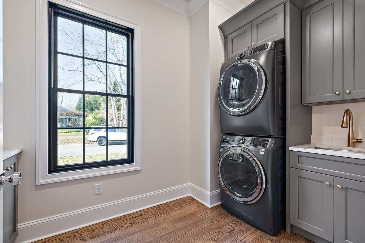 Laundry room with utility sink in Delaware custom home by Bromwell Construction