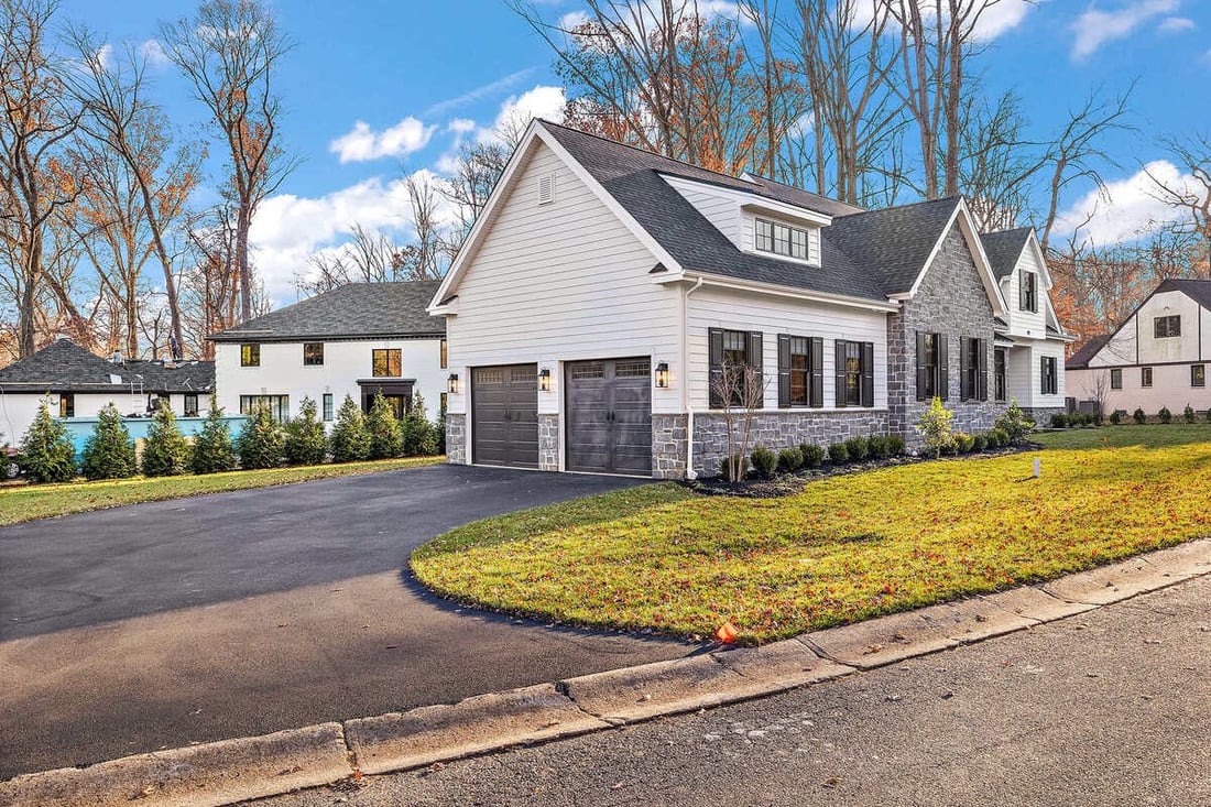 Side exterior of custom home with two-car garage in Delaware by Bromwell Construction