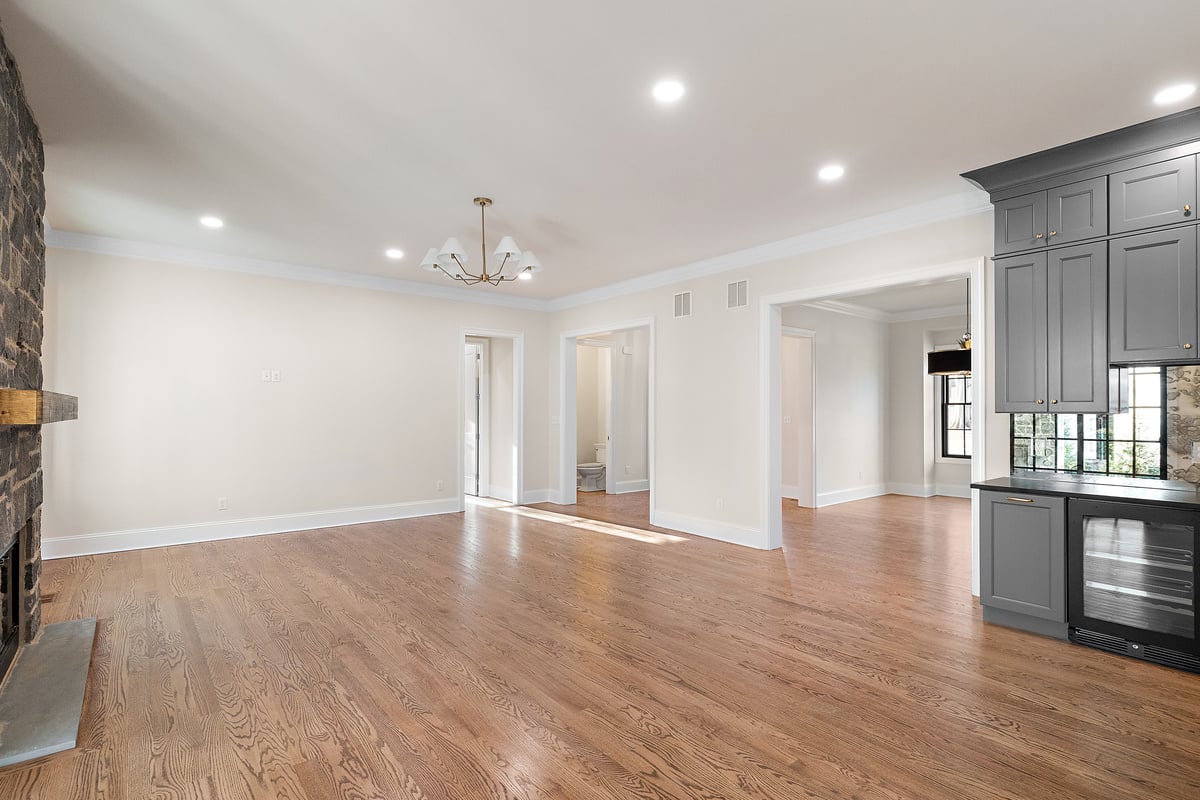 Open-concept living room space next to kitchen in Delaware custom home by Bromwell Construction