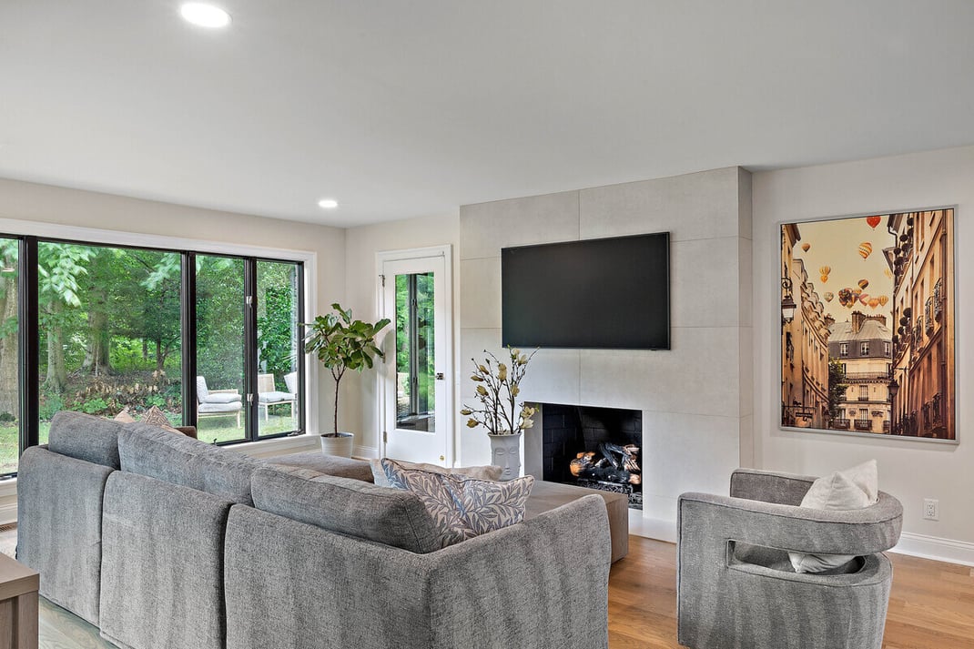 Custom living room space with floor-to-ceiling windows designed and built by Bromwell Construction