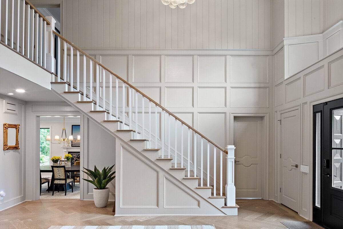 Staircase in foyer of home remodel in DE by Bromwell Construction