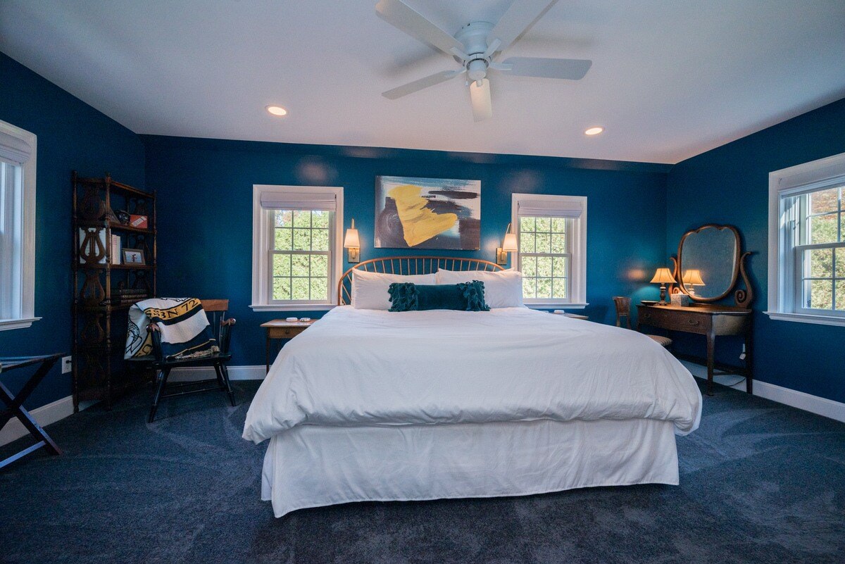 Bedroom with blue painted walls and carpet in Delaware pool house addition by Bromwell Construction