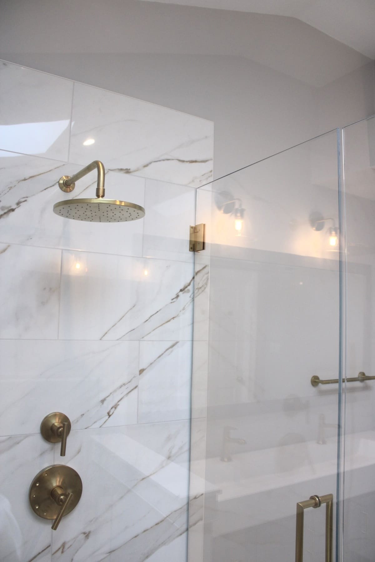 Brass shower head and faucet fixtures in Delaware bathroom remodel by Bromwell Construction