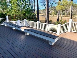Wooden deck with white fencing and bench seating