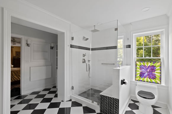 Custom bathroom addition in Delaware with walk-in shower and black and white floor tiling