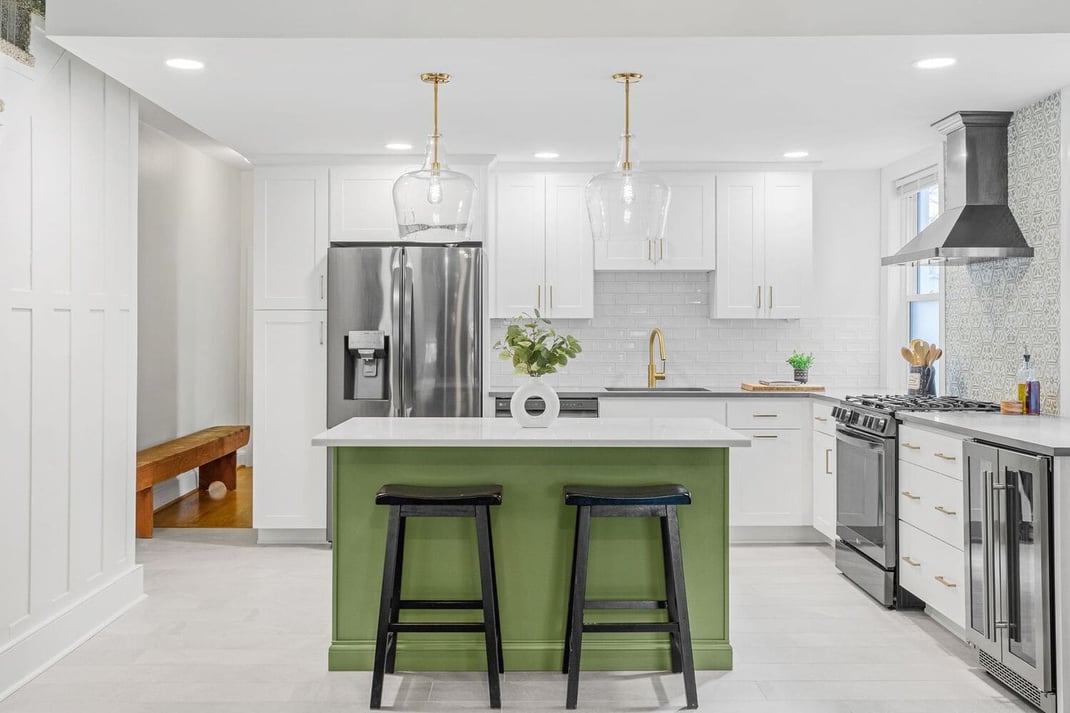 Delaware Kitchen remodel with white cabinetry and gold fixtures and view of island with green base
