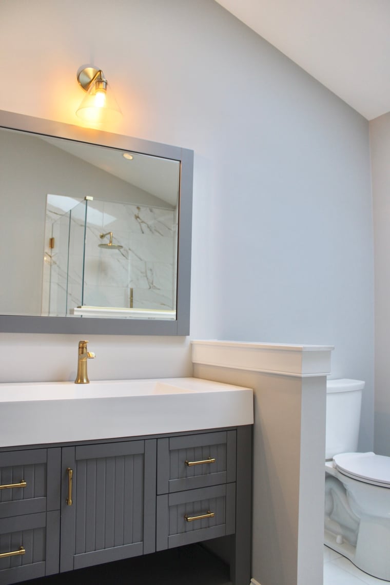 Delaware bathroom remodel by Bromwell Construction with brass fixtures