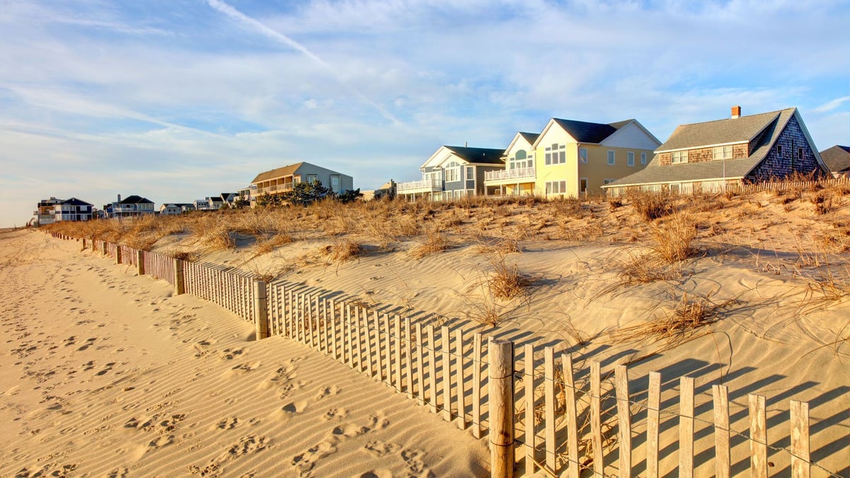 Delaware beach with view of homes and dunes