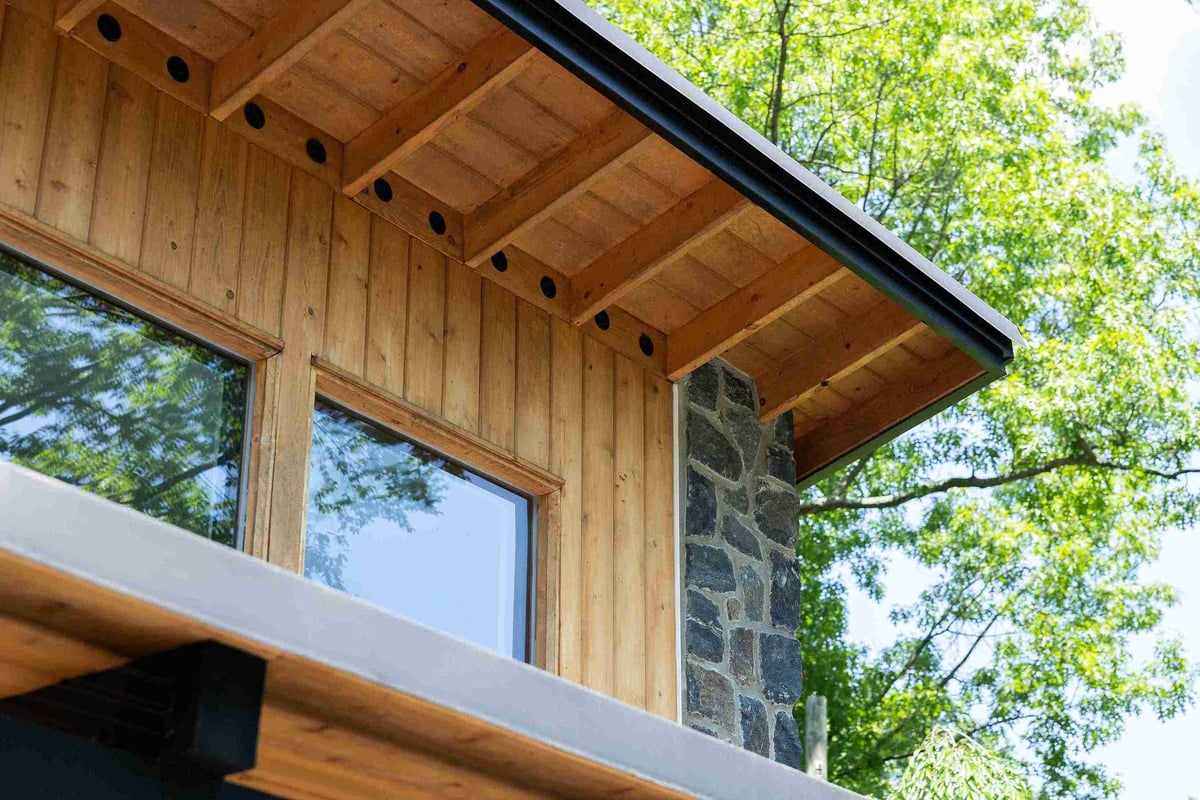 Exterior of Delaware garage addition with stone and wood siding material by Bromwell Construction