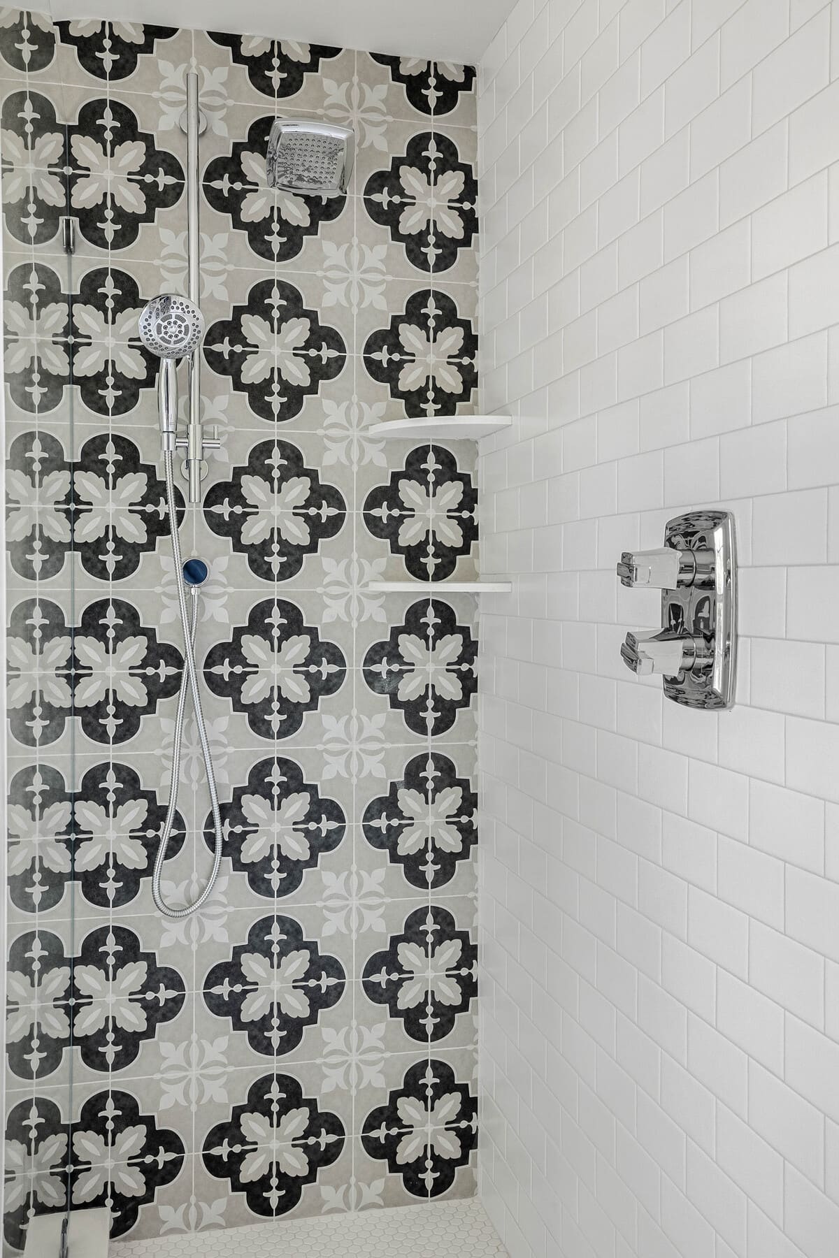 Geometric tile accent wall in walk-in shower remodel by Bromwell Construction