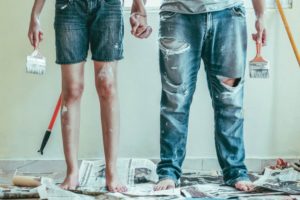 people in jeans covered in paint from painting their home