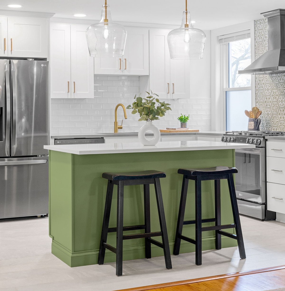 Kitchen island with green base and two pendant light fixtures above in high-end kitchen remodel in Wilmington, Delaware