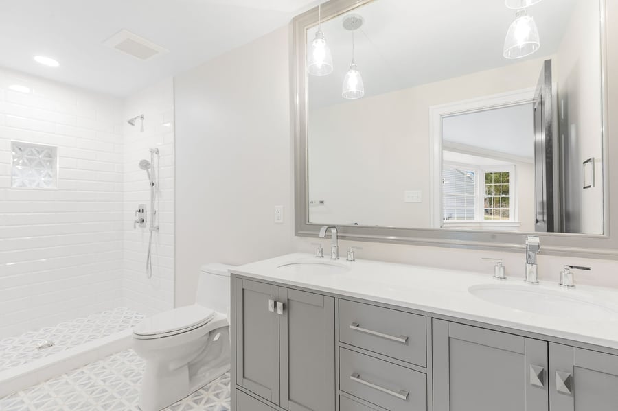 Luxury bathroom in Wilmington, DE home with gray double vanity and walk-in shower