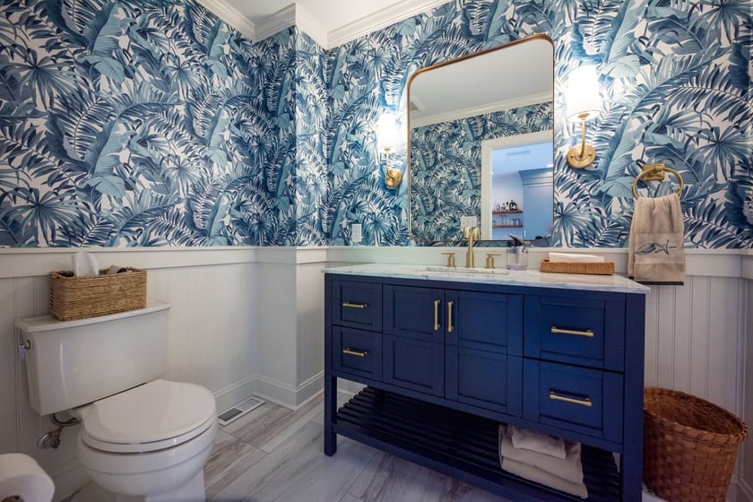 Luxury bathroom remodel in Delaware with blue vanity and wallpaper