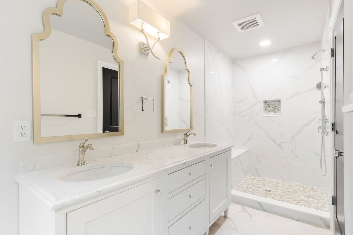 Luxury bathroom remodel in Delaware with white double vanity and walk-in shower