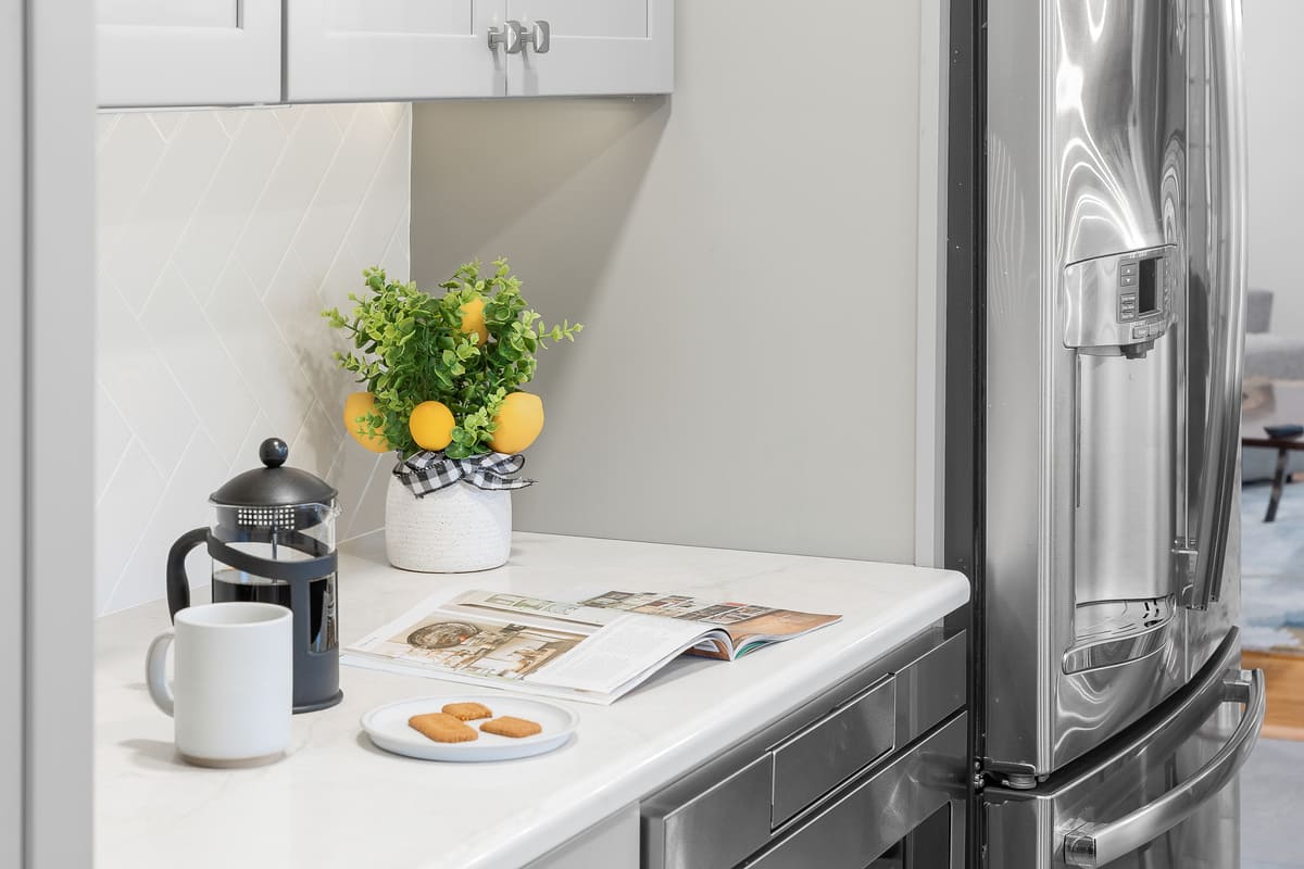 Magazine, coffee, and plate on countertop in Delaware kitchen by Bromwell Construction