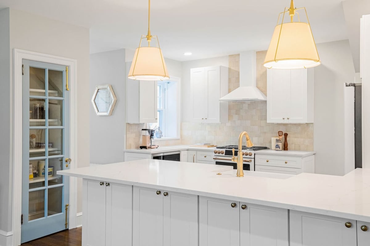 Modern bathroom renovation with white shaker cabinets and L-shaped island in Delaware