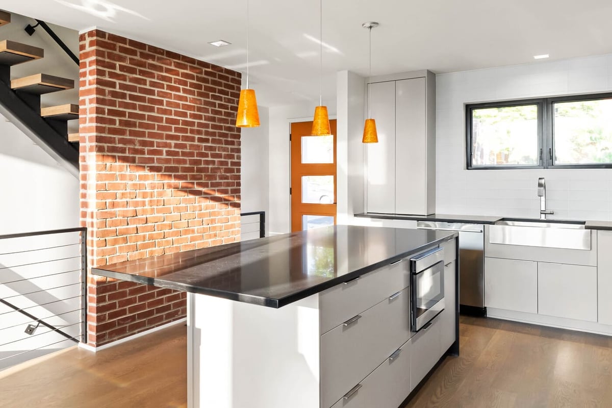 Modern kitchen in custom home in Delaware with white flat panel cabinetry