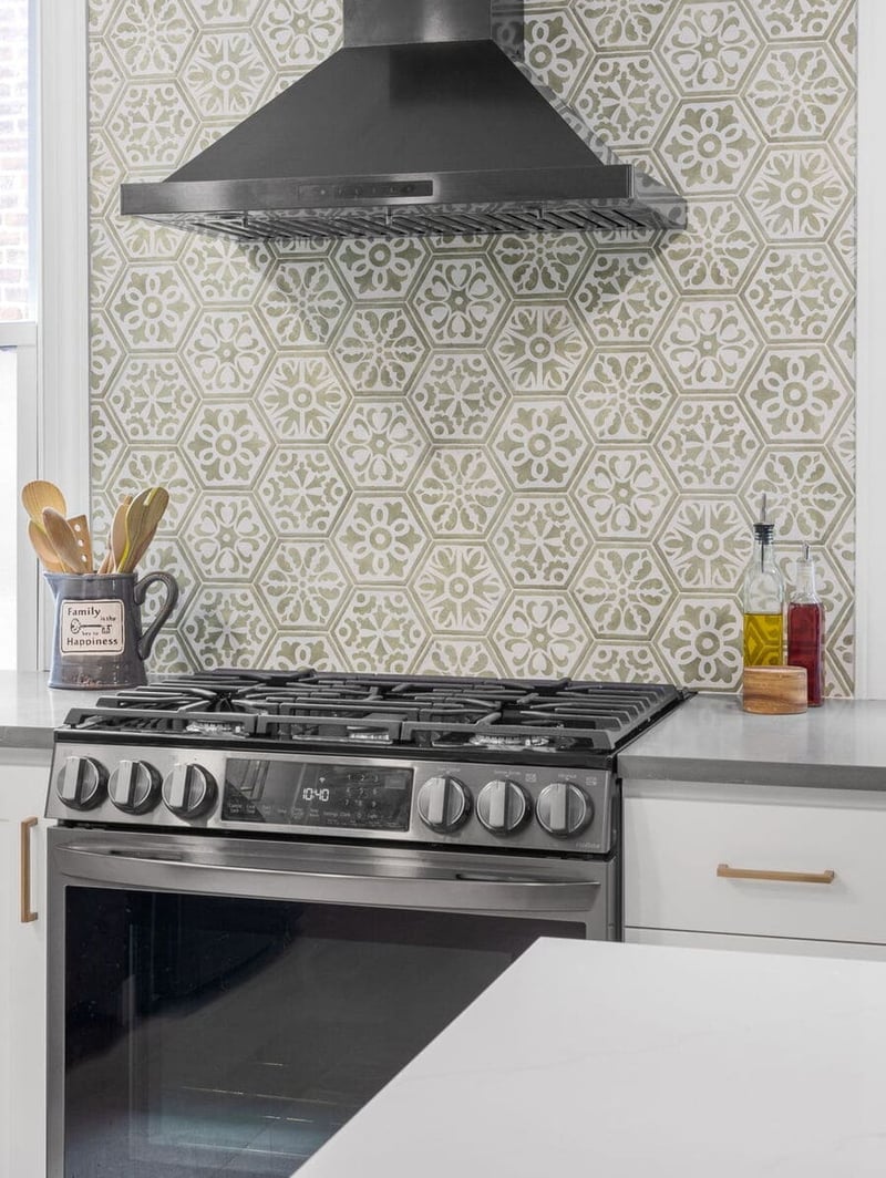 Mosaic patterned backsplash behind range hood in Delaware kitchen remodel