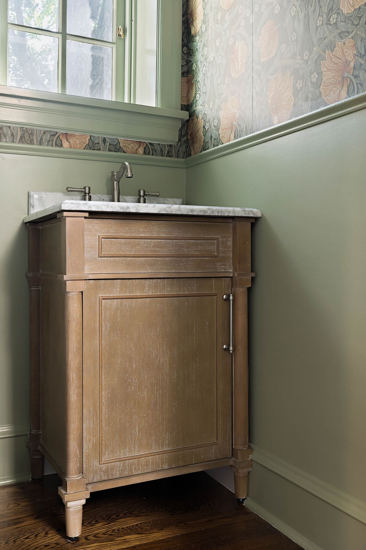 Natural wood vanity in green powder room remodel by Bromwell Constructiona