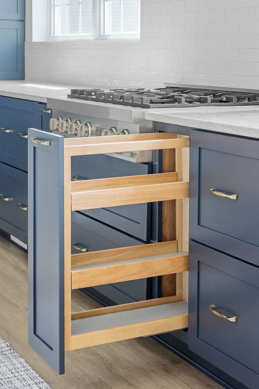 Pull-out spice drawer in modern Delaware kitchen remodel with blue finish