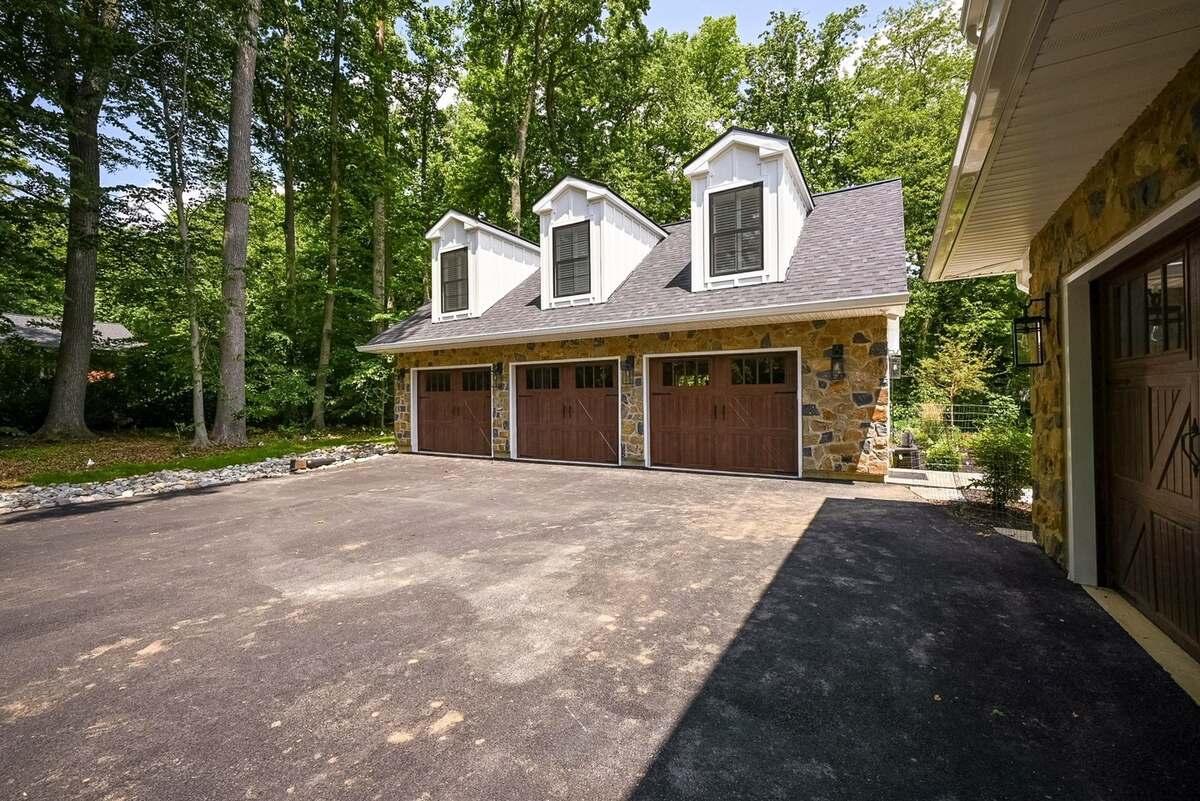 Three-car garage addition in Delaware with stone siding