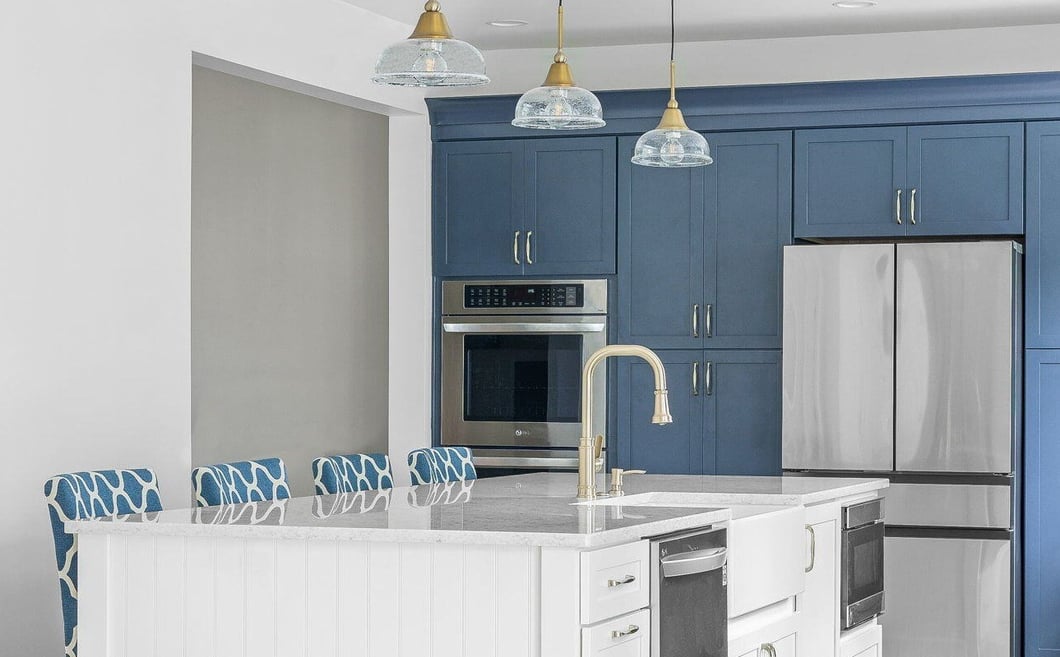 Two-tone blue and white kitchen remodel with island and seating in DE