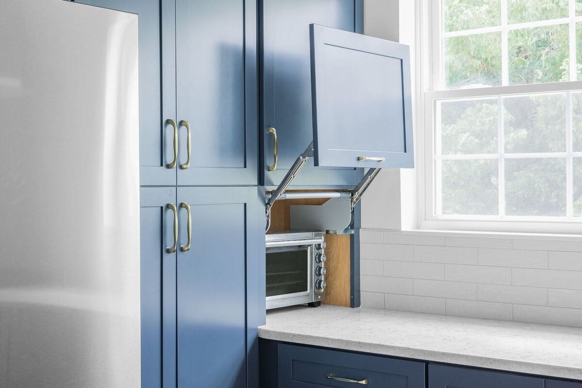 Custom blue kitchen cabinets with hidden toaster oven drawer