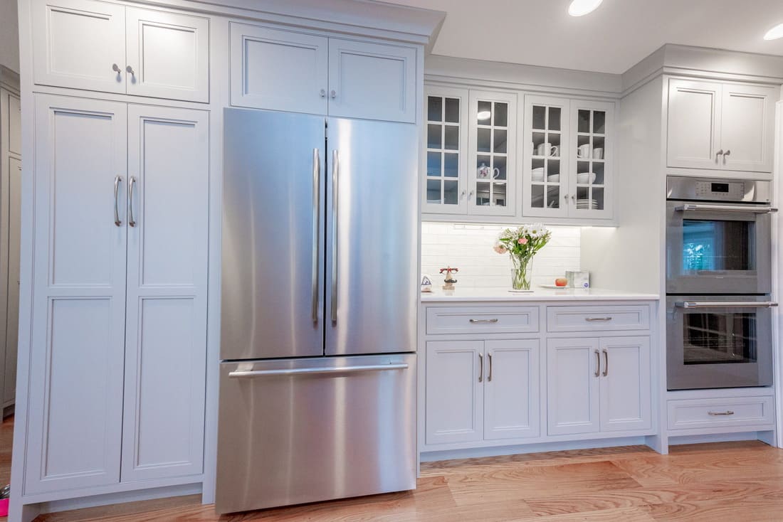 Custom cabinetry in kitchen with floor-to-ceiling and glass cabinets