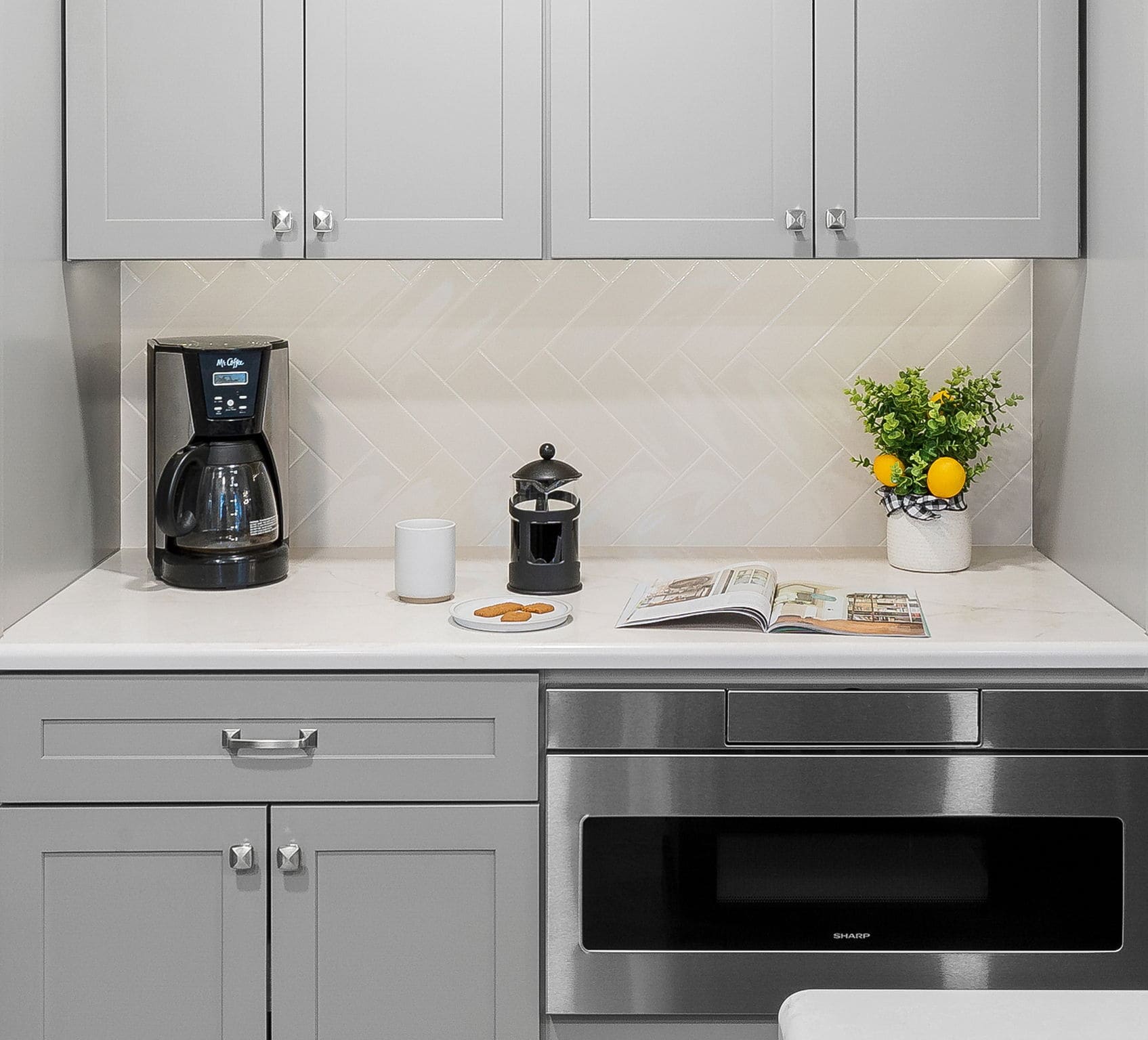 Gray shaker cabinets and white countertop in high-end remodel