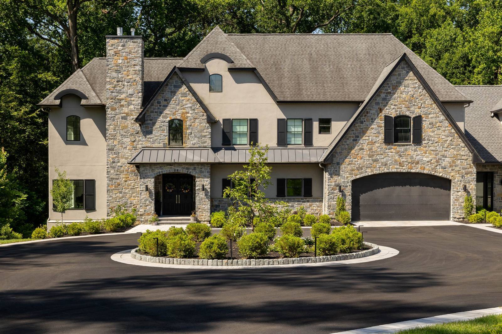 Wide exterior view of stone and stucco tudor style home in Wilmington, DE Wide exterior view of stone and stucco tudor style home in Wilmington, DE