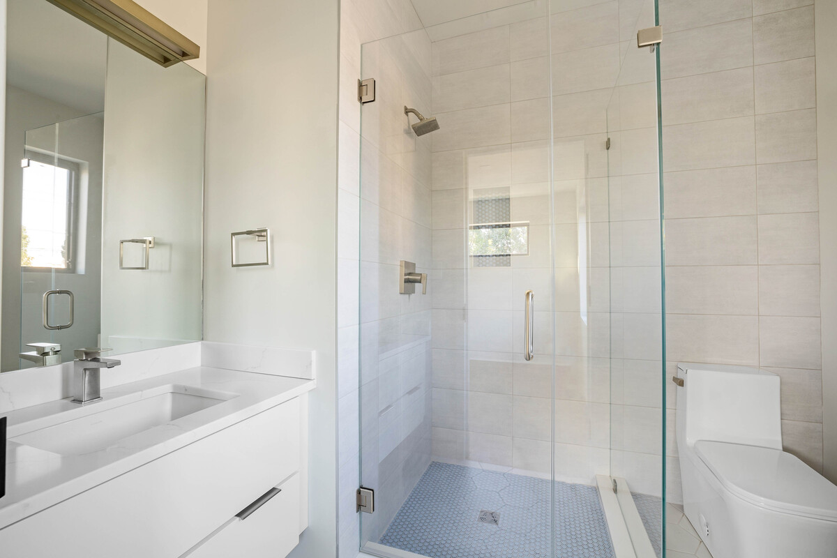 Luxury bathroom in Delaware custom home with walk-in shower behind glass door